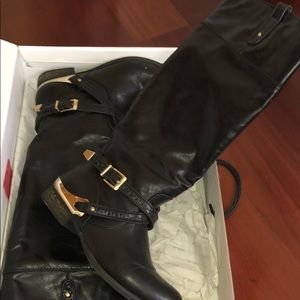 Women’s black and gold boots to the knee